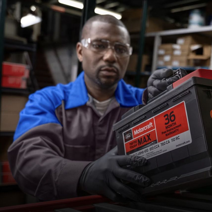 Ford technician holding a Motorcraft Tested Tough MAX battery